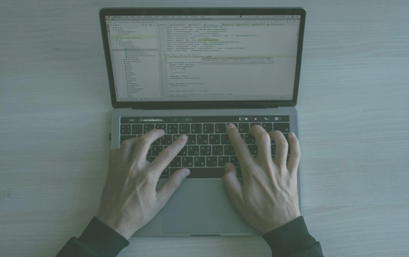 Developer working on performance optimization with multiple monitors showing code and performance metrics